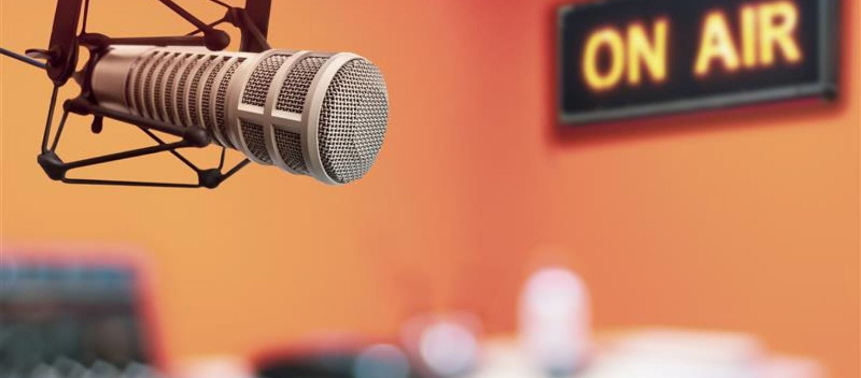 an old fashioned microphone with an on air sign behind it