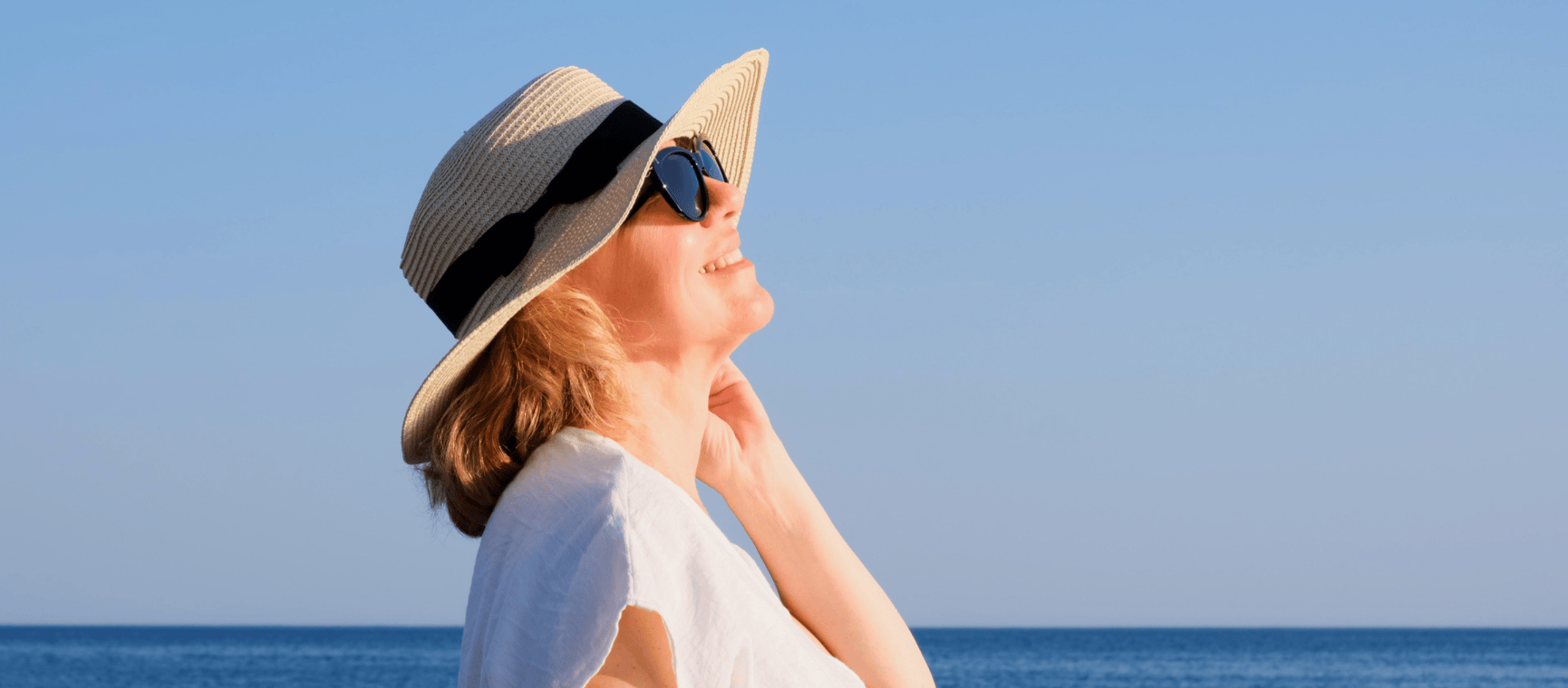 a woman in a sunhat and sunglasses