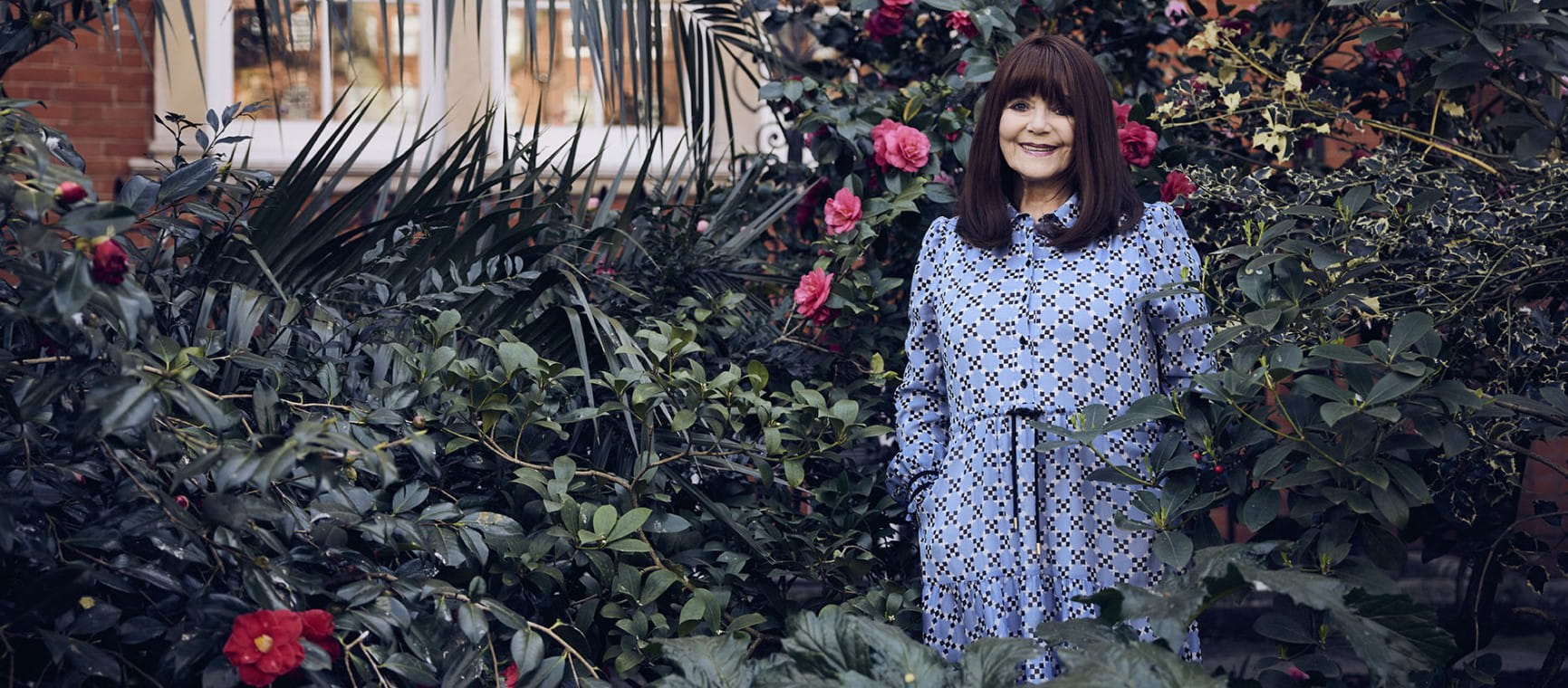 Dr Miriam Stoppard amongst plants during her Saga photoshoot